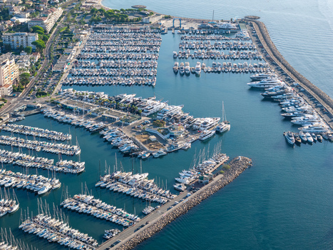 Aerial view of the extensive Port Vauban marina filled with numerous yachts and sailboats docked along the piers Antibes Provence Alpes Cote d Azur France. Aerial view of the extensive Port Vauban marina filled with numerous yachts and sailboats docked along the piers Antibes Provence Alpes Cote d Azur France.