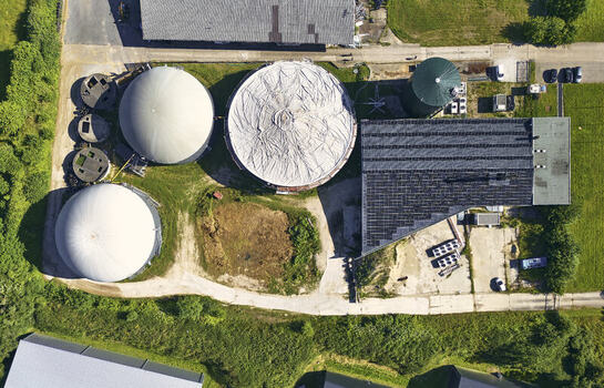 Schleswig Germany 26 June 2026 Aerial view of the biogas plant with large fermentation tanks storage domes and industrial buildings surrounded by green fields. Schleswig Germany 26 June 2026 Aerial view of the biogas plant with large fermentation tanks storage domes and industrial buildings surrounded by green fields.