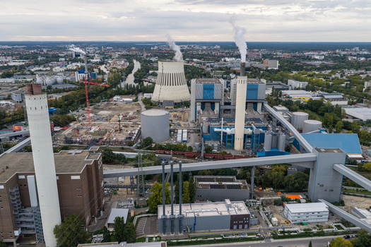 Aerial view of the Heizkraftwerk Reuter West power plant with its cooling tower and smokestacks amidst industrial infrastructure and urban landscape in Berlin Berlin Germany.
