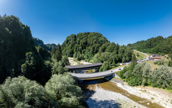 Aerial view of Sodbachbrucke Sense spanning the Sense river surrounded by lush green forests and rolling hills in Heitenried Freiburg Switzerland. Aerial view of Sodbachbrucke Sense spanning the Sense river surrounded by lush green forests and rolling hills in Heitenried Freiburg Switzerland.