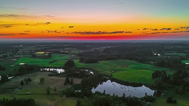 Aerial view of sunset over green fields and ponds Latvia. Aerial view of sunset over green fields and ponds Latvia.