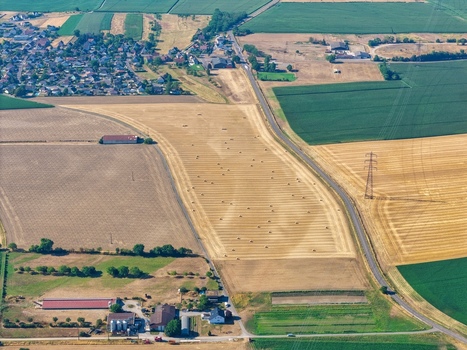 Aerial view of Hombourg showing harvested wheat fields with hay bales rural farm buildings and surrounding agricultural landscape in Hombourg Grand Est France. Aerial view of Hombourg showing harvested wheat fields with hay bales rural farm buildings and surrounding agricultural landscape in Hombourg Grand Est France.