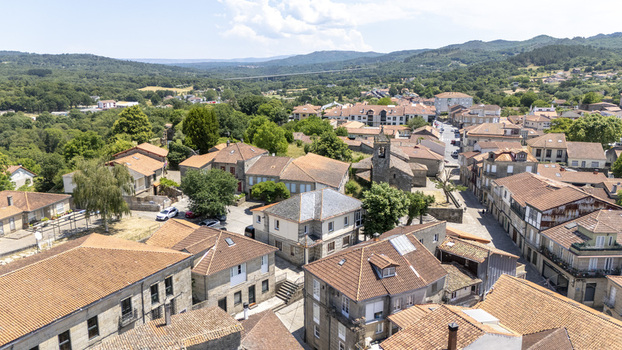 Aerial view of the historic town of Allariz with traditional stone buildings terracotta rooftops and narrow streets surrounded by lush green hills in Allariz Province of Ourense Spain. Aerial view of the historic town of Allariz with traditional stone buildings terracotta rooftops and narrow streets surrounded by lush green hills in Allariz Province of Ourense Spain.