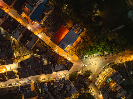 Aerial view of illuminated city streets and buildings at night in Udaipur Rajasthan India.