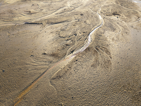 Aerial view of intricate water carved sand textures and patterns along a riverbed in Poland. Aerial view of intricate water carved sand textures and patterns along a riverbed in Poland.