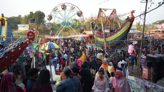 View of a crowded fair with a ferris wheel in Faridpur Bangladesh. View of a crowded fair with a ferris wheel in Faridpur Bangladesh.
