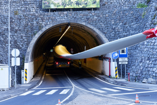 Estreito da Calheta Portugal 20 September 2026 View of a massive wind turbine blade being transported on a heavy duty truck through the entrance of the Tunel da Calheta. Estreito da Calheta Portugal 20 September 2026 View of a massive wind turbine blade being transported on a heavy duty truck through the entrance of the Tunel da Calheta.