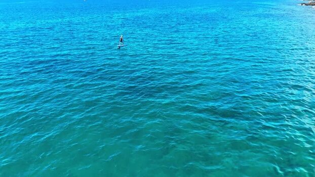 Aerial view of a person on a hydrofoil in the ocean United States. Aerial view of a person on a hydrofoil in the ocean United States.