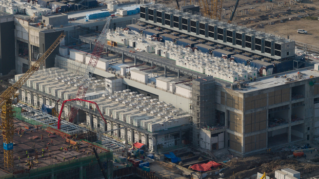 Aerial view of the Bridge Data Center under construction with cooling units industrial cranes and workers on site in Khlong Tamru Chon Buri Thailand. Aerial view of the Bridge Data Center under construction with cooling units industrial cranes and workers on site in Khlong Tamru Chon Buri Thailand.