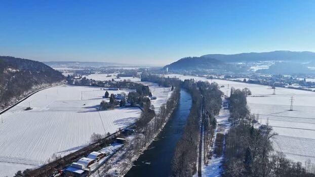 Aerial view of the snowy Mur river valley near Wildon Austria.