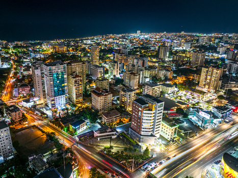 Aerial view of the intersection of Avenida Tiradentes and Avenida 27 de Febrero at night with illuminated skyscrapers and busy streets in Santo Domingo Distrito Nacional Dominican Republic. Aerial view of the intersection of Avenida Tiradentes and Avenida 27 de Febrero at night with illuminated skyscrapers and busy streets in Santo Domingo Distrito Nacional Dominican Republic.