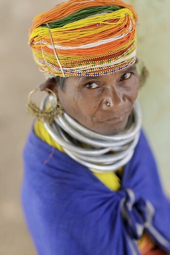 Odisha India 26 March 2026 View of a tribal woman adorned with striking silver neck rings and a vibrant multicolored turban her gaze captivating against a muted backdrop. Odisha India 26 March 2026 View of a tribal woman adorned with striking silver neck rings and a vibrant multicolored turban her gaze captivating against a muted backdrop.