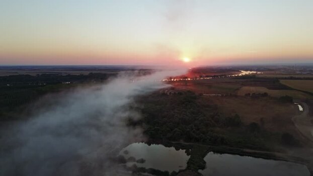Aerial view of smoke over the river at sunset in Serbia.