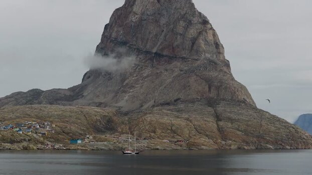 Aerial view of Uummannaq mountain and coastal settlement Greenland. Aerial view of Uummannaq mountain and coastal settlement Greenland.