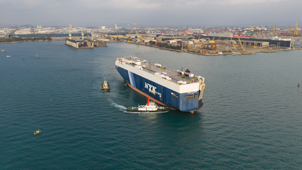 Si Racha District Thailand 08 March 2026 Aerial view of a large NYK Line cargo ship being assisted by tugboats near the Laem Chabang International Terminal B 5 Terminal. Si Racha District Thailand 08 March 2026 Aerial view of a large NYK Line cargo ship being assisted by tugboats near the Laem Chabang International Terminal B 5 Terminal.
