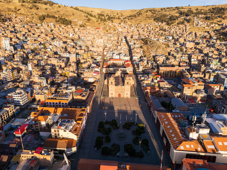Aerial view of the Cathedral of Puno situated in the central plaza surrounded by historic urban architecture and hilly landscape in Puno Puno Peru.