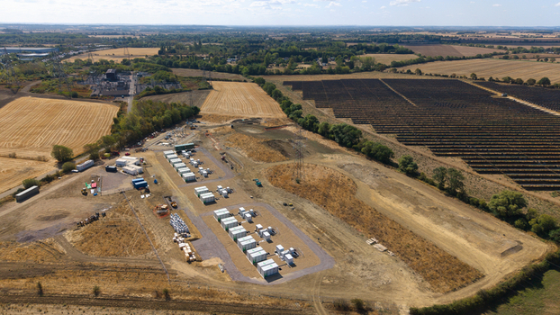Aerial view of Eaton Socon Substation featuring solar farm arrays and battery energy storage systems surrounded by rural fields in St. Neots England United Kingdom. Aerial view of Eaton Socon Substation featuring solar farm arrays and battery energy storage systems surrounded by rural fields in St. Neots England United Kingdom.