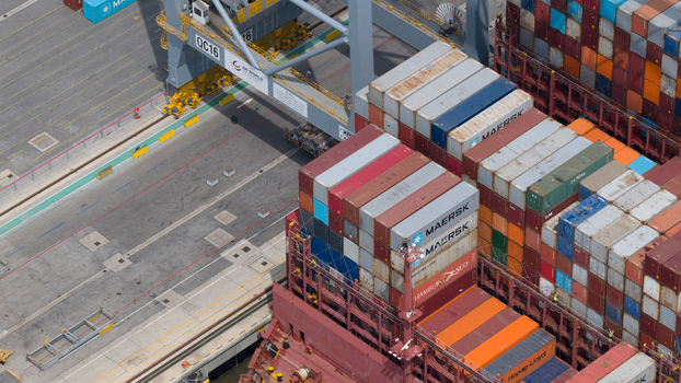 Corringham United Kingdom 10 July 2026 Aerial view of Solent Stevedores London Gateway container terminal with stacks of colorful shipping containers and a large crane.