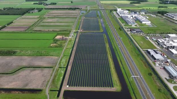 Aerial view of a large solar farm next to a highway Netherlands.