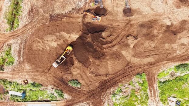 Aerial view of construction site with excavators in India.