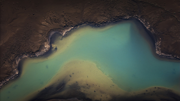 Aerial view of the turquoise glacial waters of Langisjor lake surrounded by dark volcanic terrain and abstract patterns in Vik Myrdalshreppur Iceland. Aerial view of the turquoise glacial waters of Langisjor lake surrounded by dark volcanic terrain and abstract patterns in Vik Myrdalshreppur Iceland.