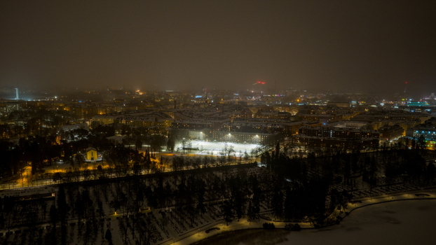 Aerial view of the Toolo district at night with illuminated buildings snow covered parks and urban street lights in Helsinki Uusimaa Finland. Aerial view of the Toolo district at night with illuminated buildings snow covered parks and urban street lights in Helsinki Uusimaa Finland.