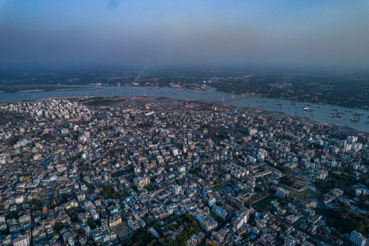 Chattogram Bangladesh 25 February 2022 Aerial view of the dense urban landscape of Chattogram featuring residential buildings commercial structures and the Karnaphuli River.