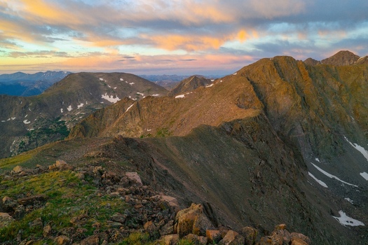 Aerial view of the rugged peaks of Mount of the Holy Cross and the Sawatch Range in the Rocky Mountains at sunset featuring rocky ridges in Vail Colorado United States. Aerial view of the rugged peaks of Mount of the Holy Cross and the Sawatch Range in the Rocky Mountains at sunset featuring rocky ridges in Vail Colorado United States.