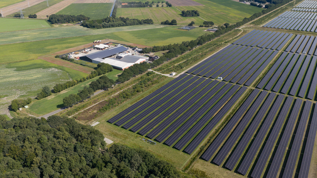 Aerial view of Zonnepark Pekela a large solar farm with rows of photovoltaic panels next to agricultural fields and a farm complex in Oude Pekela Groningen Netherlands. Aerial view of Zonnepark Pekela a large solar farm with rows of photovoltaic panels next to agricultural fields and a farm complex in Oude Pekela Groningen Netherlands.