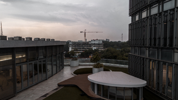 Accra Greater Accra Region Ghana 25 July 2024 Aerial view of the Ecobank Ghana Plc head office rooftop terrace featuring modern architecture greenery and a distant crane under a cloudy sky. Accra Greater Accra Region Ghana 25 July 2024 Aerial view of the Ecobank Ghana Plc head office rooftop terrace featuring modern architecture greenery and a distant crane under a cloudy sky.