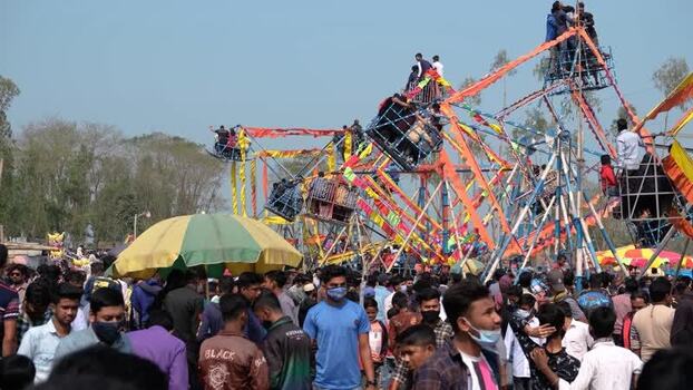 View of a crowded fairground with a Ferris wheel Bangladesh. View of a crowded fairground with a Ferris wheel Bangladesh.