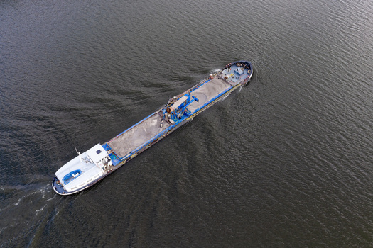 Aerial view of Harderhaven with a cargo ship navigating the water in Zeewolde Flevoland Netherlands.
