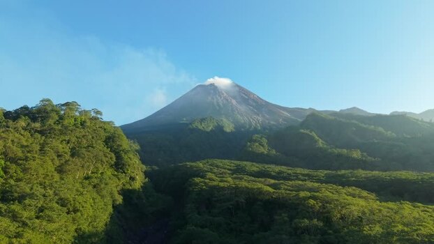 Aerial view of Mount Merapi volcano and green forests Indonesia.