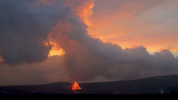 View of lava flow and smoke plume at sunset United States.