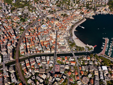 Aerial view of the coastal town of Rapallo featuring colorful buildings a sandy beach and a marina filled with boats along the Ligurian coast in Rapallo Liguria Italy. Aerial view of the coastal town of Rapallo featuring colorful buildings a sandy beach and a marina filled with boats along the Ligurian coast in Rapallo Liguria Italy.