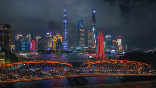 Aerial view of the illuminated Waibaidu Bridge at night with the Pudong skyline Oriental Pearl Tower and modern skyscrapers across the river in Shanghai Shanghai China. Aerial view of the illuminated Waibaidu Bridge at night with the Pudong skyline Oriental Pearl Tower and modern skyscrapers across the river in Shanghai Shanghai China.