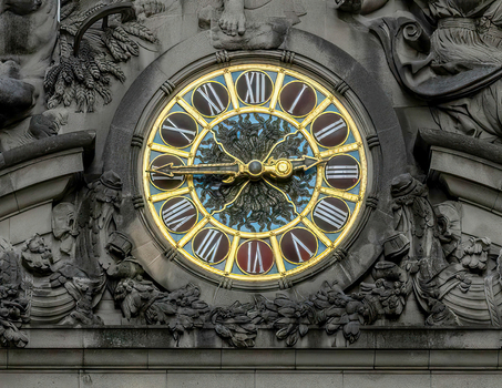 View of the iconic Tiffany glass clock and ornate stone sculptures on the facade of Grand Central Terminal New York New York United States. View of the iconic Tiffany glass clock and ornate stone sculptures on the facade of Grand Central Terminal New York New York United States.