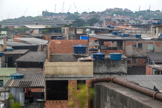 View of densely packed brick houses and rooftops with blue water tanks in an urban neighborhood in Rio de Janeiro Rio de Janeiro Brazil.
