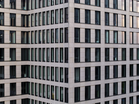 Aerial view of the geometric facade and textures on building elevation of a modern office tower in Krakow Lesser Poland Voivode Poland. Aerial view of the geometric facade and textures on building elevation of a modern office tower in Krakow Lesser Poland Voivode Poland.