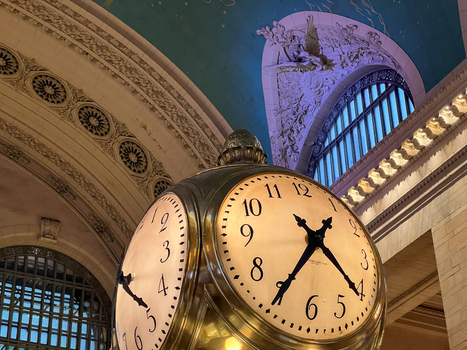 View of the iconic four faced opal clock in the Main Concourse of Grand Central Terminal with the celestial ceiling and ornate architecture in New York New York United States. View of the iconic four faced opal clock in the Main Concourse of Grand Central Terminal with the celestial ceiling and ornate architecture in New York New York United States.