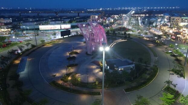 Aerial view of the illuminated Orchestra monument on Golf Island featuring surrounding roads and urban lighting in Kecamatan Penjaringan Daerah Khusus Ibukota Indonesia. Aerial view of the illuminated Orchestra monument on Golf Island featuring surrounding roads and urban lighting in Kecamatan Penjaringan Daerah Khusus Ibukota Indonesia.