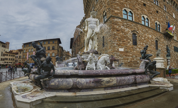 Florence Italy 05 May 2022 View of the Fountain of Neptune in Piazza della Signoria with its marble statue and bronze figures set against the historic Palazzo Vecchio facade. Florence Italy 05 May 2022 View of the Fountain of Neptune in Piazza della Signoria with its marble statue and bronze figures set against the historic Palazzo Vecchio facade.