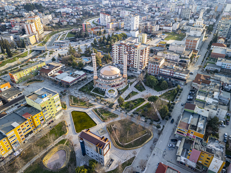 Aerial view of Fier Mosque surrounded by urban buildings parks and streets in Fier Fier County Albania. Aerial view of Fier Mosque surrounded by urban buildings parks and streets in Fier Fier County Albania.