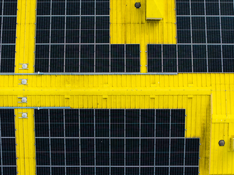 Aerial view of solar panels on a bright yellow industrial roof Valdlauci Kekava Municipality Latvia. Aerial view of solar panels on a bright yellow industrial roof Valdlauci Kekava Municipality Latvia.
