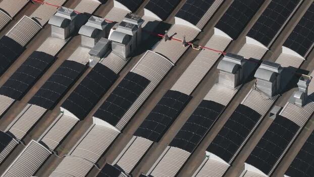 Aerial view of industrial roof with solar panels Italy.