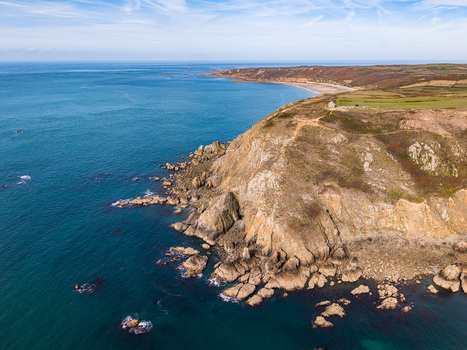 Aerial view of Nez de Jobourg cliffs featuring rugged rock formations turquoise sea and green coastal fields in La Hague Normandie France. Aerial view of Nez de Jobourg cliffs featuring rugged rock formations turquoise sea and green coastal fields in La Hague Normandie France.