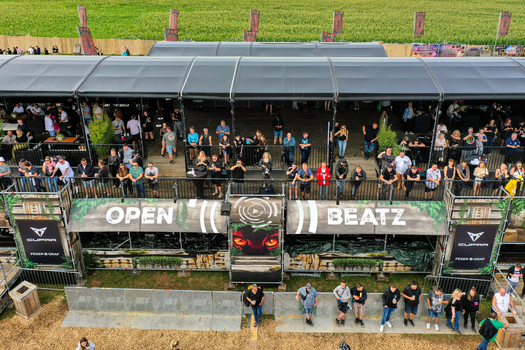 Herzogenaurach Germany 27 July 2025 Aerial view of Open Beatz Festival with people gathered on a large covered platform overlooking a green field. Herzogenaurach Germany 27 July 2025 Aerial view of Open Beatz Festival with people gathered on a large covered platform overlooking a green field.