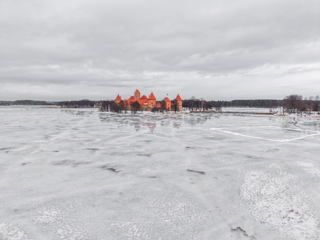 Aerial view of Trakai Island Castle surrounded by a frozen lake under a cloudy sky in Trakai Vilnius County Lithuania. Aerial view of Trakai Island Castle surrounded by a frozen lake under a cloudy sky in Trakai Vilnius County Lithuania.