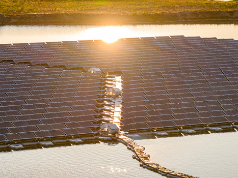 Aerial view of solar panels reflecting golden sunlight on a calm lake surface during sunset Bensheim Hessen Germany. Aerial view of solar panels reflecting golden sunlight on a calm lake surface during sunset Bensheim Hessen Germany.