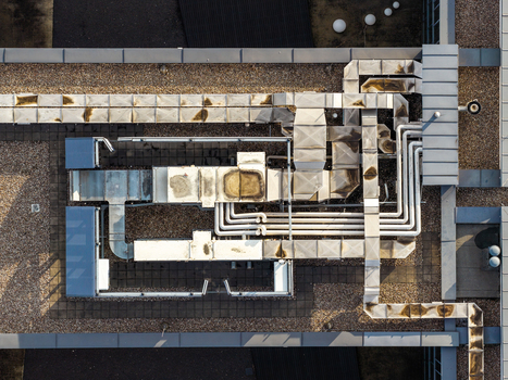 Aerial view of HVAC ventilation systems on the rooftop of a production company office building in Masovian Voivodeship Poland.